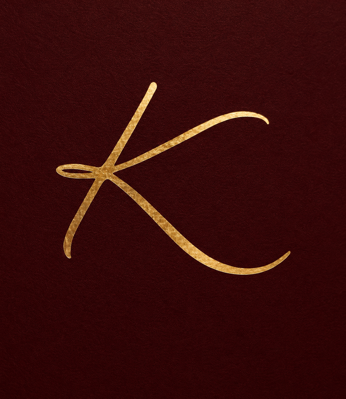 The K, in gold on burgundy