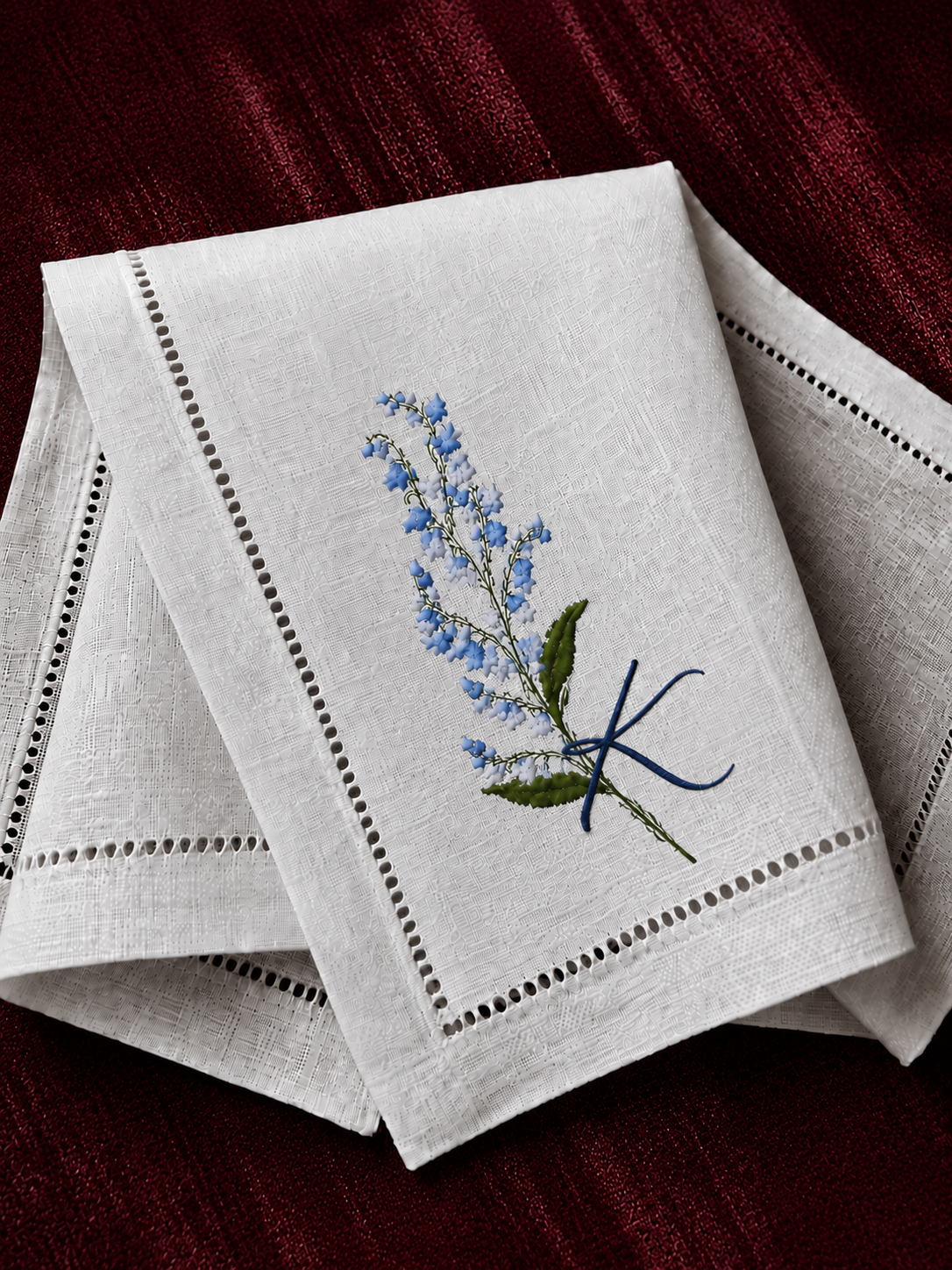 The napkin, embroidered with K